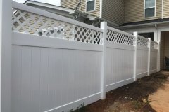 Vinyl fence with decorative lattice top, showcasing durability and elegance, ideal for enhancing residential properties.